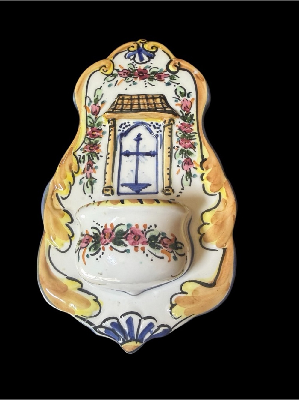 Hand-painted ceramic Talavera holy water font with floral and cross motifs.